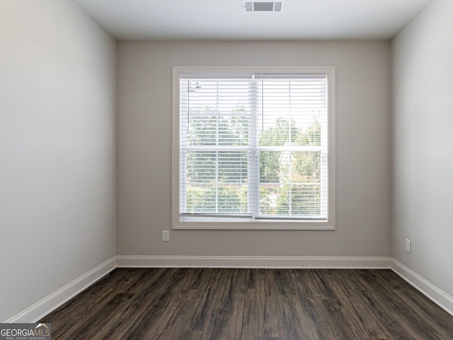 empty room featuring dark wood-type flooring