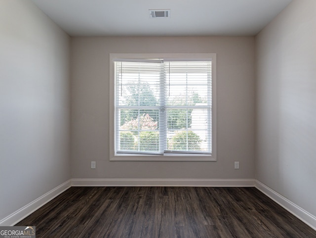 unfurnished room with dark hardwood / wood-style floors