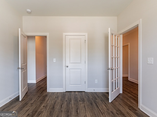 unfurnished bedroom with dark hardwood / wood-style floors