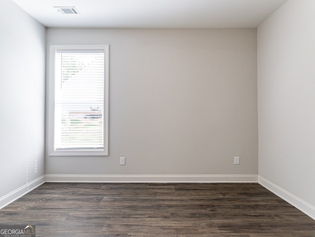 unfurnished room with a wealth of natural light and hardwood / wood-style flooring