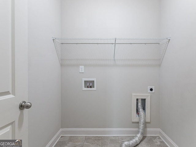 washroom with hookup for a washing machine, hookup for an electric dryer, and light tile patterned floors