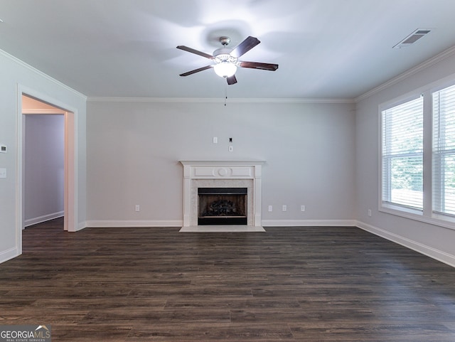 unfurnished living room with ceiling fan, crown molding, dark hardwood / wood-style flooring, and a premium fireplace