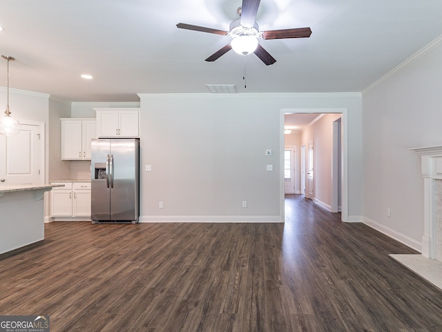 unfurnished living room with ceiling fan, ornamental molding, and dark hardwood / wood-style floors