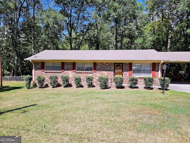 ranch-style home with a carport and a front lawn