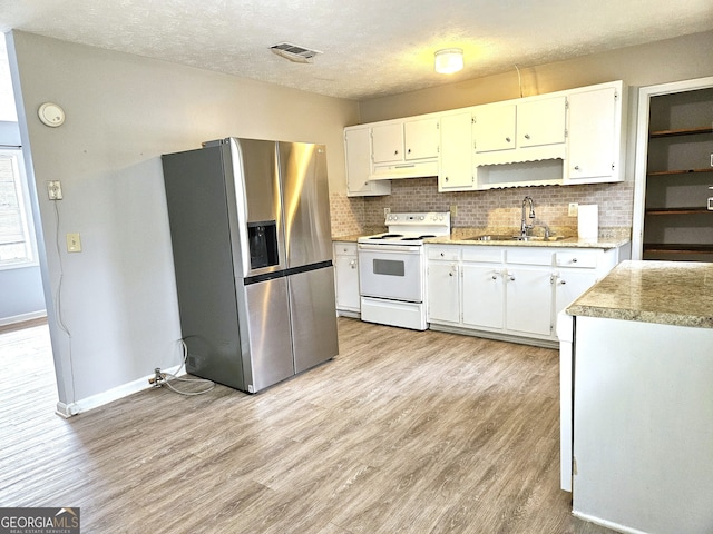 kitchen featuring white cabinets, stainless steel refrigerator with ice dispenser, sink, light wood-type flooring, and white electric stove