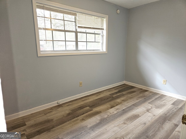 empty room with wood-type flooring