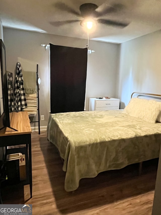 bedroom featuring hardwood / wood-style floors and ceiling fan