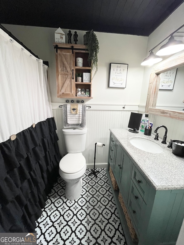 bathroom with vanity, toilet, and tile patterned flooring