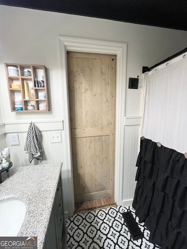 bathroom featuring hardwood / wood-style flooring and vanity