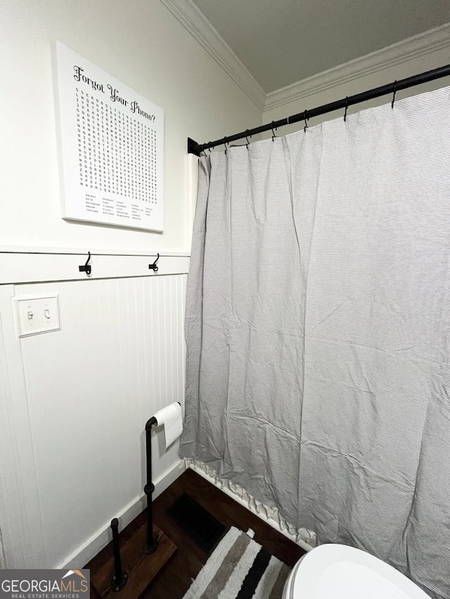 bathroom with toilet and ornamental molding