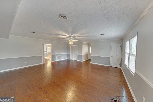 unfurnished living room with crown molding, hardwood / wood-style flooring, and a textured ceiling