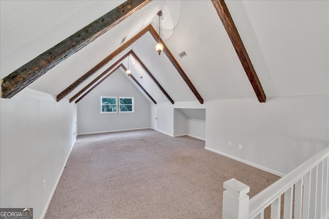 additional living space with lofted ceiling, carpet flooring, and a textured ceiling