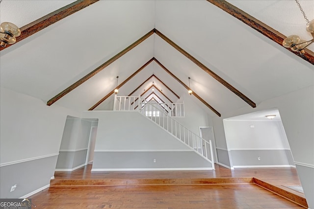 interior space with hardwood / wood-style floors and vaulted ceiling