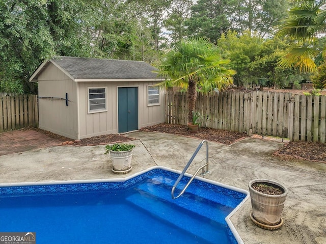 view of swimming pool featuring an outbuilding and a patio area