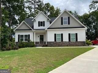 craftsman inspired home with a front lawn