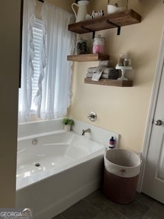 bathroom featuring a tub and tile patterned flooring