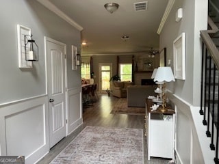 living room with ornamental molding and wood-type flooring