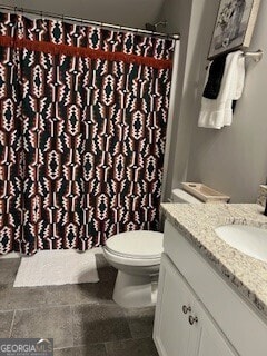 bathroom with vanity, tile patterned flooring, and toilet