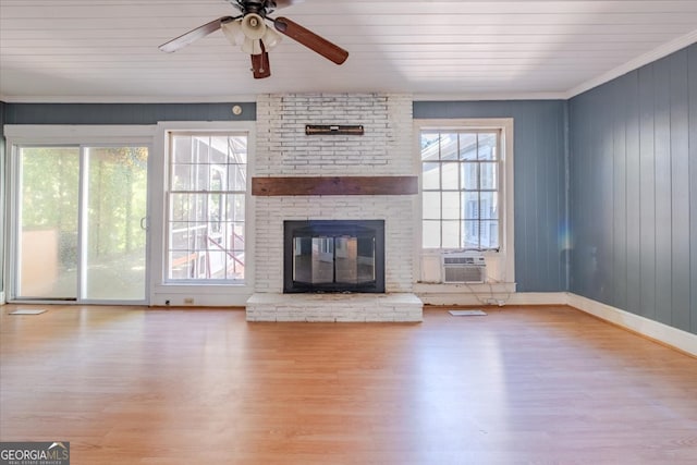 unfurnished living room with a brick fireplace, light hardwood / wood-style floors, and plenty of natural light