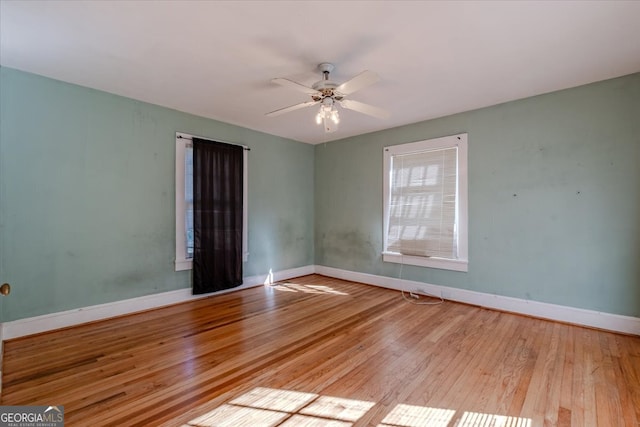 spare room featuring light wood-type flooring and ceiling fan