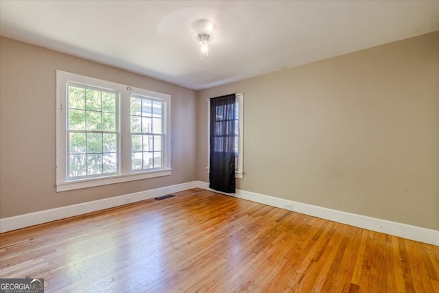 unfurnished room featuring light hardwood / wood-style floors