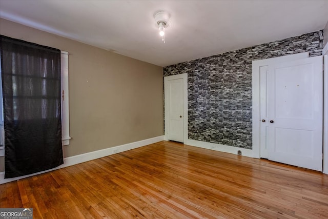 unfurnished room with light wood-type flooring