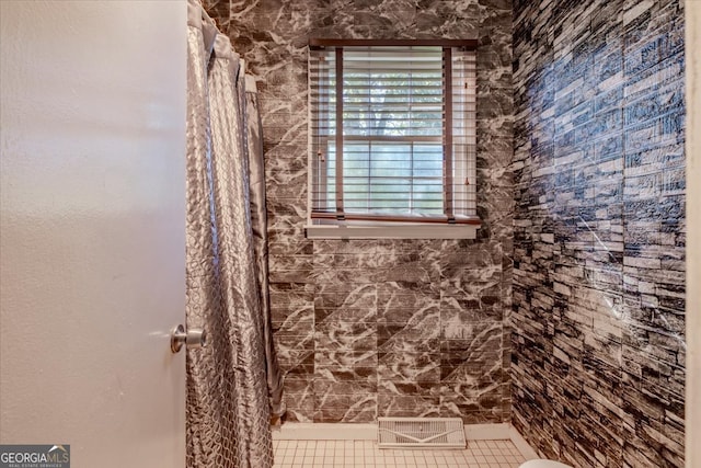 bathroom featuring tile patterned floors and curtained shower