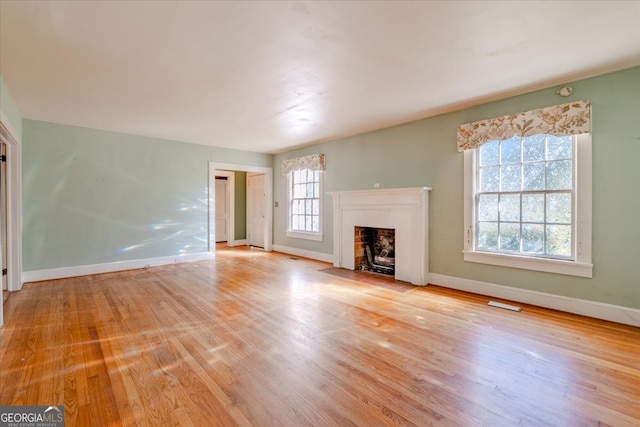 unfurnished living room featuring light wood-type flooring