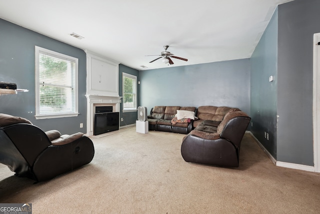 carpeted living room with ceiling fan