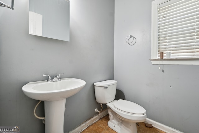 bathroom featuring tile patterned floors, a wealth of natural light, and toilet