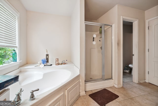 bathroom with plus walk in shower, toilet, and tile patterned floors