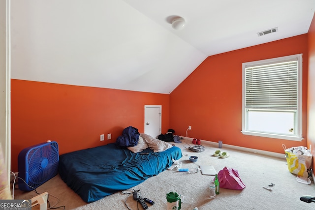 bedroom featuring carpet floors and vaulted ceiling