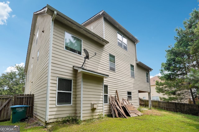 back of property featuring a yard