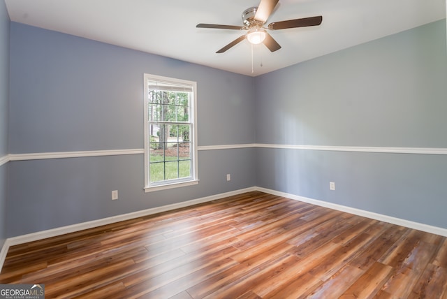 spare room with ceiling fan and wood-type flooring