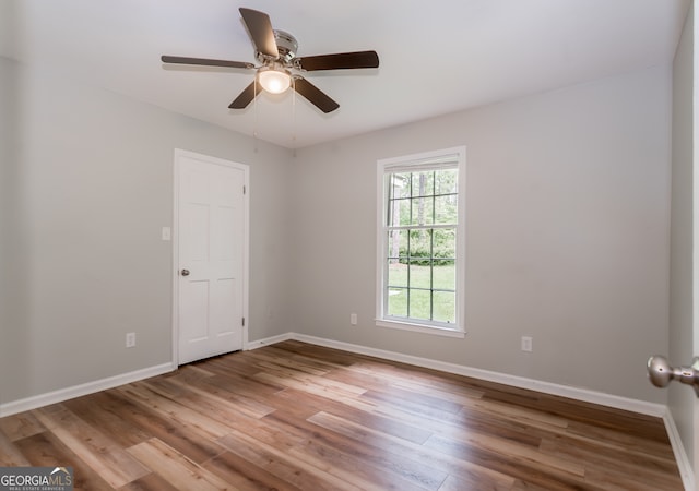 empty room featuring hardwood / wood-style floors and ceiling fan