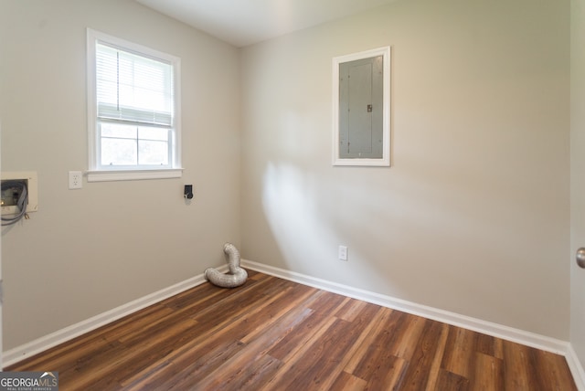 clothes washing area with electric panel, dark hardwood / wood-style floors, and electric dryer hookup