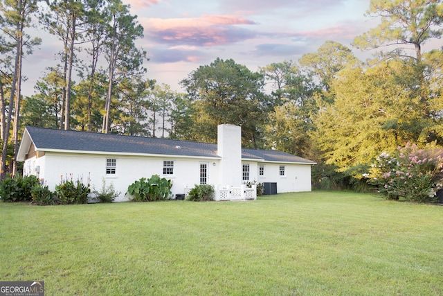 back house at dusk with a yard