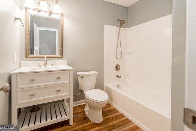 full bathroom with shower / bathing tub combination, hardwood / wood-style flooring, vanity, and toilet