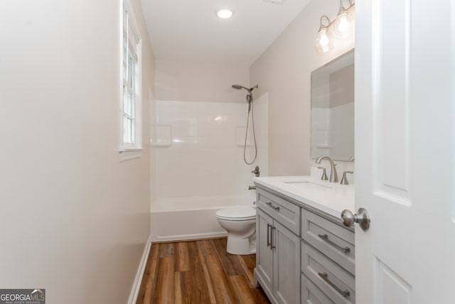 full bathroom with bathing tub / shower combination, vanity, toilet, and hardwood / wood-style flooring