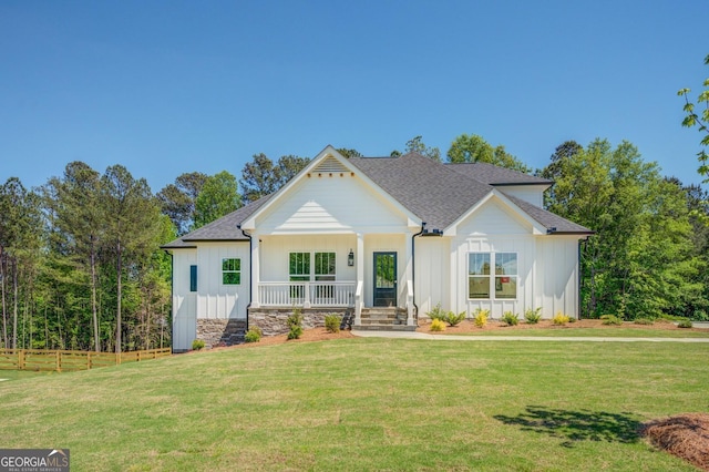 view of front facade with covered porch and a front lawn