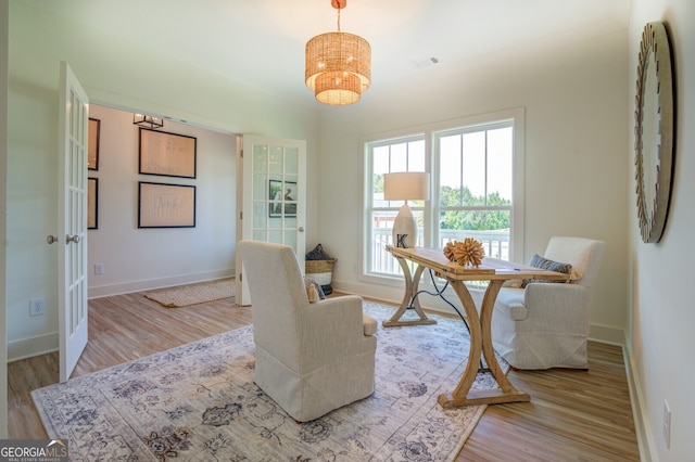 interior space with light hardwood / wood-style flooring and a notable chandelier