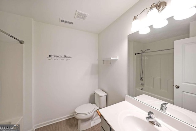 bathroom with washtub / shower combination, visible vents, vanity, and toilet