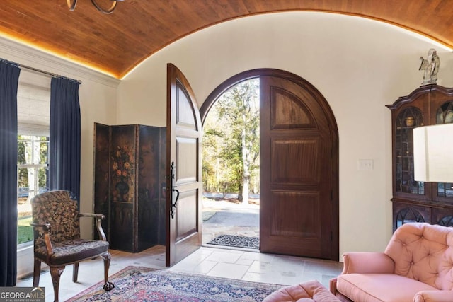 entryway with a wealth of natural light, light tile patterned floors, and wood ceiling