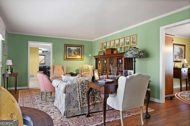 living room featuring hardwood / wood-style floors and ornamental molding