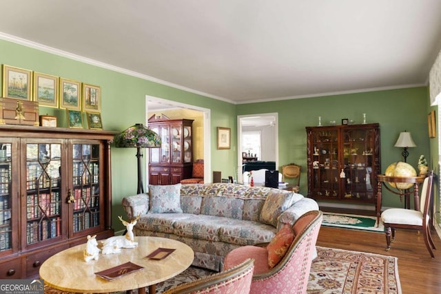 living room featuring hardwood / wood-style flooring and crown molding