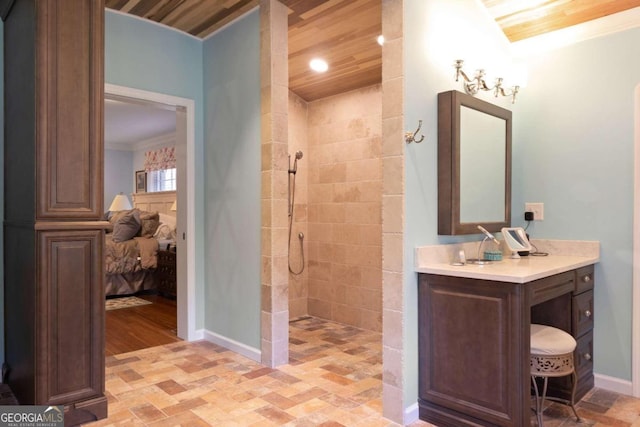 bathroom featuring ornamental molding, tiled shower, tile patterned floors, vanity, and wood ceiling