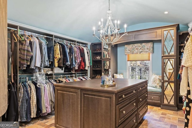 walk in closet featuring a notable chandelier and light tile patterned floors