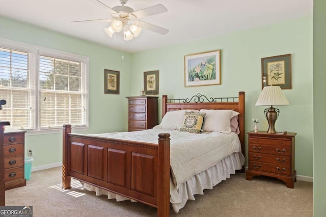 bedroom with ceiling fan and light colored carpet