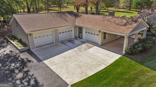 view of front of property featuring a garage and a front lawn