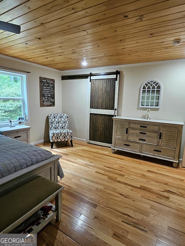 bedroom featuring wooden ceiling, light hardwood / wood-style flooring, ornamental molding, and a barn door